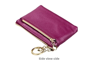 Macro side view of purple leather coin purse with golden heart pendant keychain detail