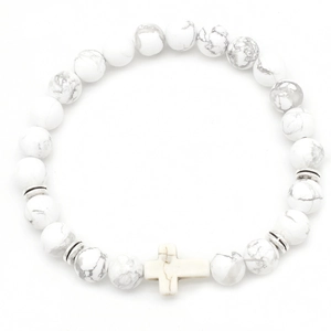 Detail of white turquoise beads bracelet with silver spacers and a white cross charm