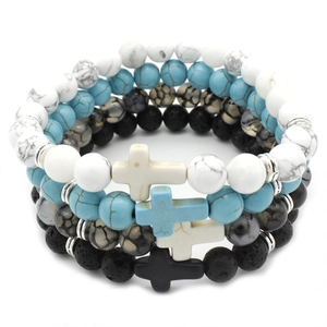 Detail of 4-piece bead bracelet set with turquoise, lava stone and cross charms