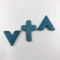 Detailed macro view of turquoise stone spacer beads in V-shape, cross, and arrow forms