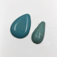 Macro shot of teardrop-shaped blue turquoise stones with natural brown veined textures
