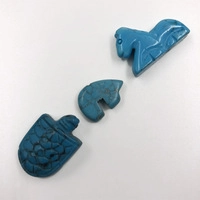 Detailed view of blue turquoise animal beads featuring a turtle, elephant, and pony shape