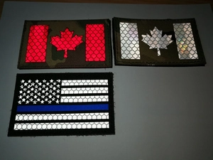 Close-up of laser-cut IR reflective tactical patches with honeycomb texture and flags