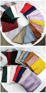 Close-up of pleated texture on colorful square scarves with fine accordion fold details
