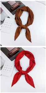 Detail of caramel and red pleated silk scarves with elegant texture on minimalist background