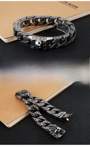 Detailed close-up of gothic skull clasp and snake scale texture on titanium steel bracelet