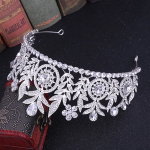 Close-up of elegant silver bridal crown with intricate crystals on vintage books