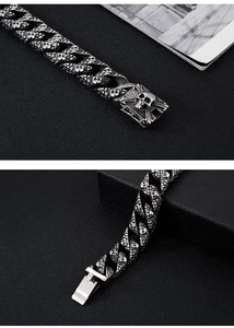 Macro view of stainless steel punk skull bracelet with detailed relief and clasp closure