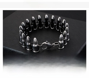Close-up of punk bullet link bracelet in polished stainless steel with lobster clasp