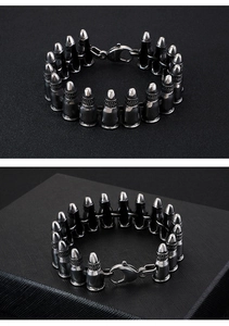Detailed view of punk style bullet link bracelet in gunmetal and silver finish