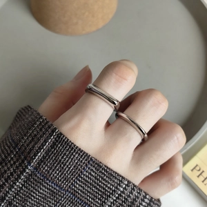 Detail of minimalist 925 sterling silver rings with polished wide and narrow bands