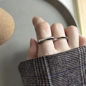 Minimalist 925 sterling silver rings with sleek irregular curves worn on fingers