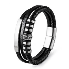 Macro detail of men's multilayer black braided leather bracelet with silver metal hardware