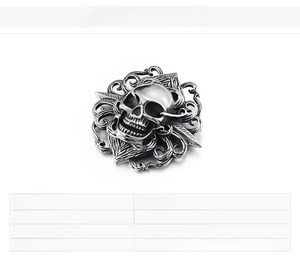 Detailed close-up of a stainless steel skull pendant with vintage gothic carvings