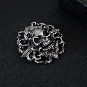 Men's stainless steel skull pendant with flame engraving on a black textured background