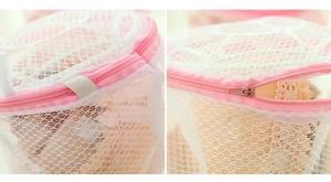 Detail of pink zipper protector and fine mesh fabric on foldable bra laundry bag