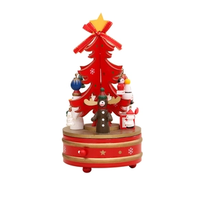 Rotating red wooden Christmas tree music box with miniature snowman and reindeer ornaments