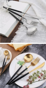 Detail of 304 stainless steel cutlery set with black handles in gold and silver finish