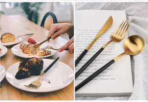 Detail of 304 stainless steel black and gold cutlery set cutting a fresh croissant