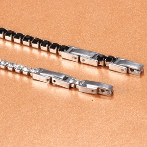 Detail of silver tennis bracelets with black and white cubic zirconia and fold-over clasps