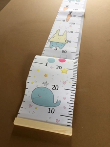Detail of canvas height chart with cute whale and rabbit patterns for kids room