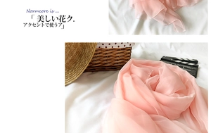 Detail of pink semi-transparent lightweight chiffon scarf with rolled edge finish