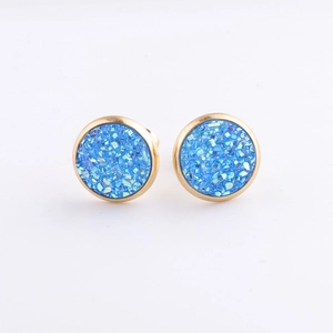 Macro shot of 10mm blue mineral cluster earrings with sparkling texture in gold setting