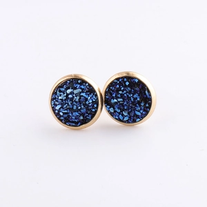 Detail of 10mm round gold-plated stainless steel studs with dark blue sparkling stone
