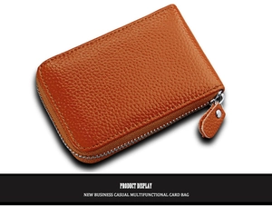 Detail of orange lychee grain leather card holder with U-shaped metal zipper and puller