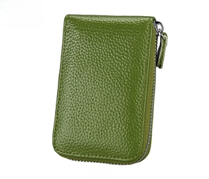 Detailed macro view of green litchi grain leather texture on zipper coin purse