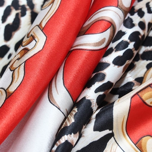 Satin silk scarf featuring classic leopard print and golden chain pattern with red borders