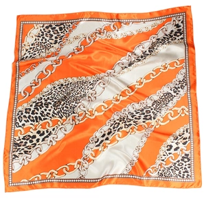Flat lay of 90cm square satin scarf featuring gold chain and leopard print patterns