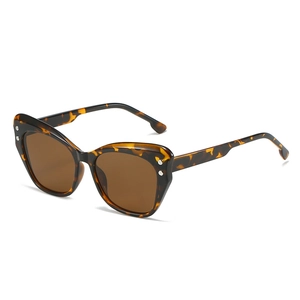Retro tortoiseshell cat eye sunglasses with brown lenses and silver dot accents