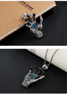 Detailed close-up of a silver dragon claw pendant featuring a striking blue eye center