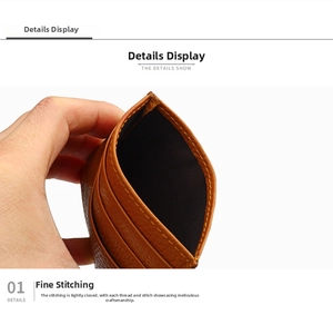 Close-up of caramel leather card holder with detailed stitching and lychee grain texture