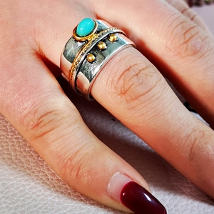 Macro shot of boho turquoise ring featuring vintage silver and gold twisted metal details