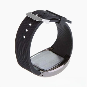 Macro detail of the stainless steel back cover and textured black silicone sport watch strap