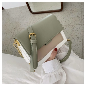 Detail of tricolor leather crossbody bag with sage green, beige, and gold buckle