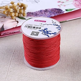 Detailed view of 1.0mm red elastic crystal string for DIY jewelry making on a 100m spool