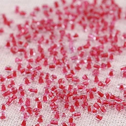 Macro shot of rose red round beads with transparent outer shell for DIY jewelry making