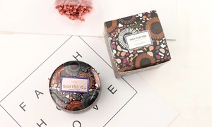 Aromatherapy soy candle set with floral tin can and matching gift box on stylish paper