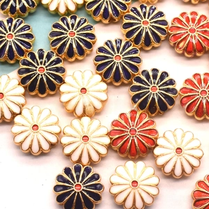 Macro shot of colorful enamel sunflower beads with metallic edges for DIY jewelry making
