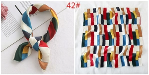 Detail view of 50x50cm geometric silk-like square scarf with colorful spliced patterns