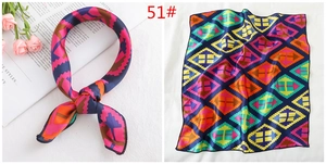 Detail of colorful geometric square scarf with high shine and silky texture drape