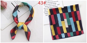 Detail of colorful geometric satin silk scarf with knot styling and flat layout view