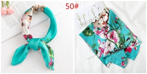 Detailed view of floral printed satin scarf in Tiffany blue with pink flower pattern