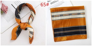 Detail of silk-texture square scarf with orange and black stripes in a stylish knot