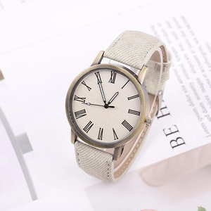 Fashion beige canvas strap watch with bronze case and roman numeral dial on paper background