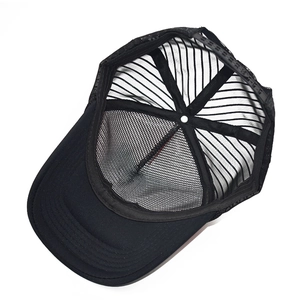 Interior view of black mesh trucker hat showing snapback closure and inner structural tape