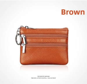 Close-up of brown litchi grain leather coin purse with three zippers and key ring